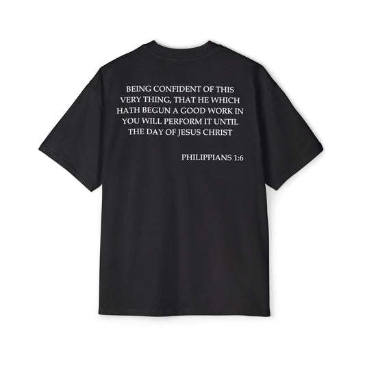 Back of Surrendered Apparel black oversized Christian T-shirt featuring the Bible verse Philippians 1:6 in bold text, providing a cozy fit perfect for cooler days and sharing faith