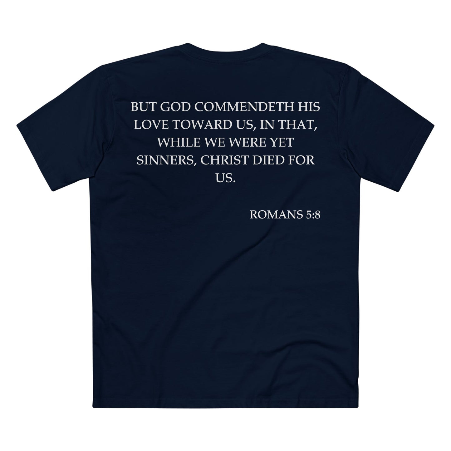 Back of Surrendered Apparel navy Christian T-shirt featuring the Bible verse Romans 5:8 in bold text, perfect for sharing faith and Jesus