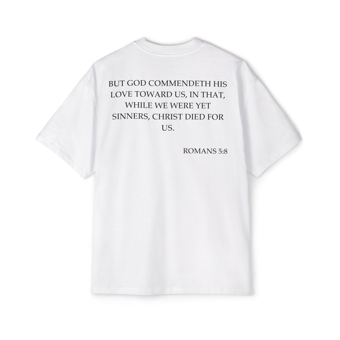 Back of Surrendered Apparel white oversized Christian T-shirt featuring the Bible verse Romans 5:8 in bold black text, providing a cozy fit perfect for cooler days and sharing faith