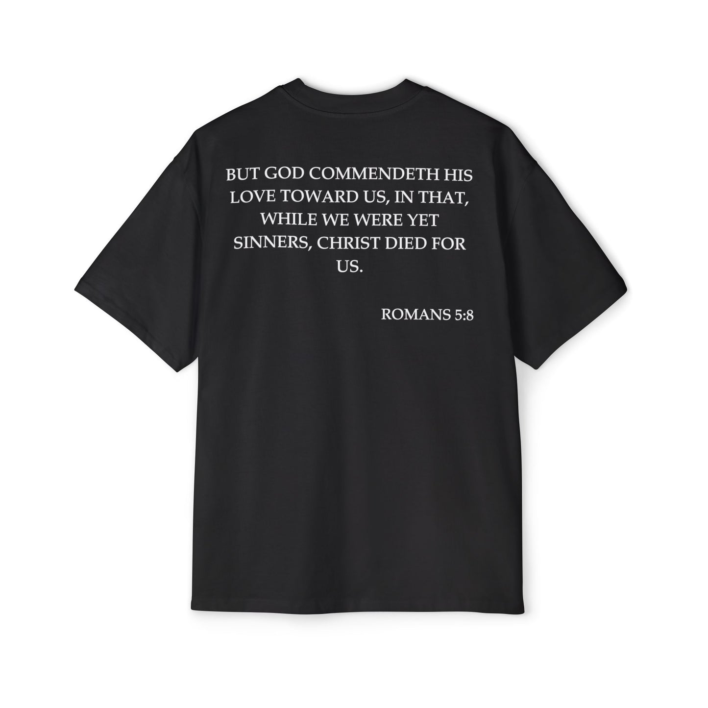 Back of Surrendered Apparel black oversized Christian T-shirt featuring the Bible verse Romans 5:8 in bold white text, providing a cozy fit perfect for cooler days and sharing faith