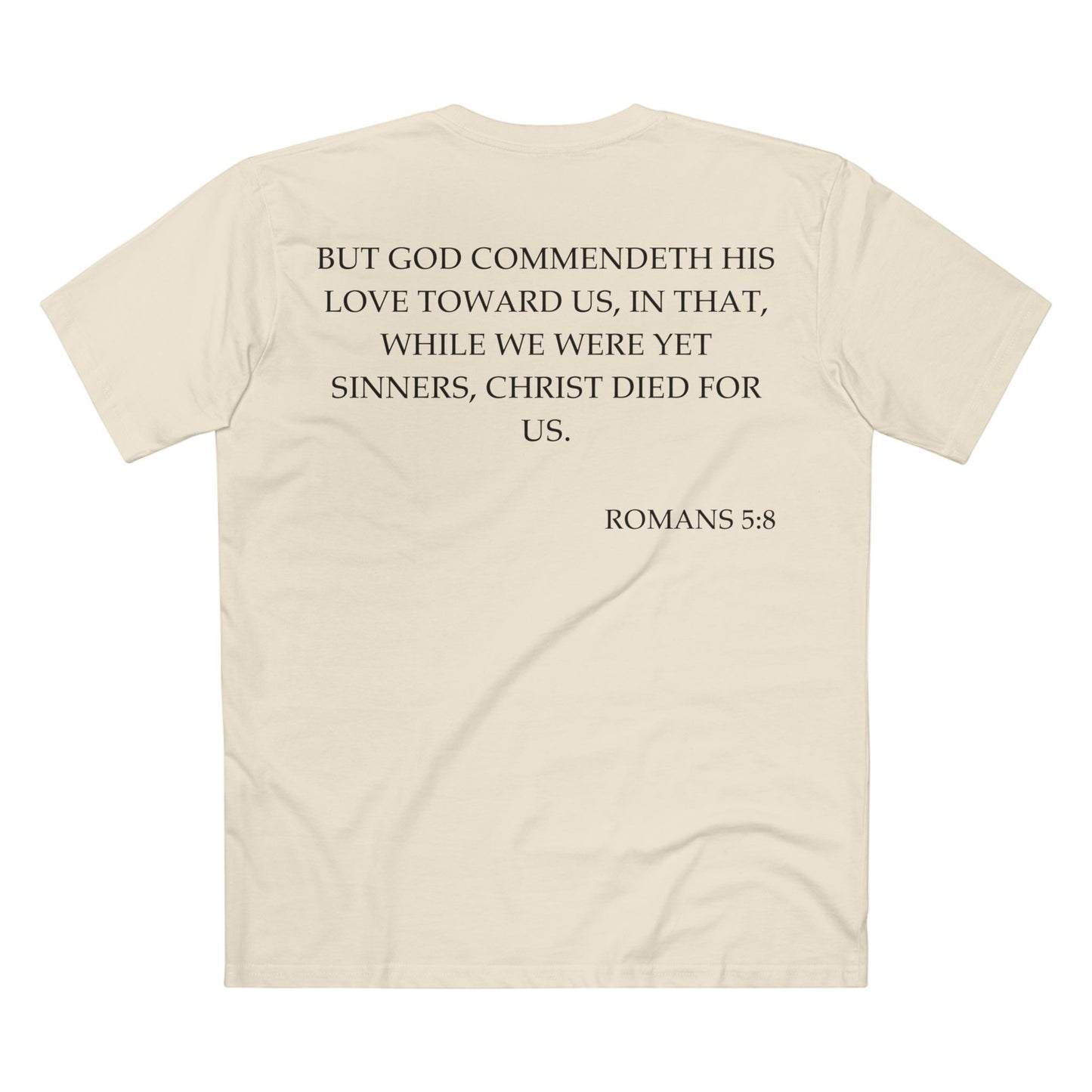 Back of Surrendered Apparel cream Christian T-shirt featuring the Bible verse Romans 5:8 in bold text, perfect for sharing faith and Jesus