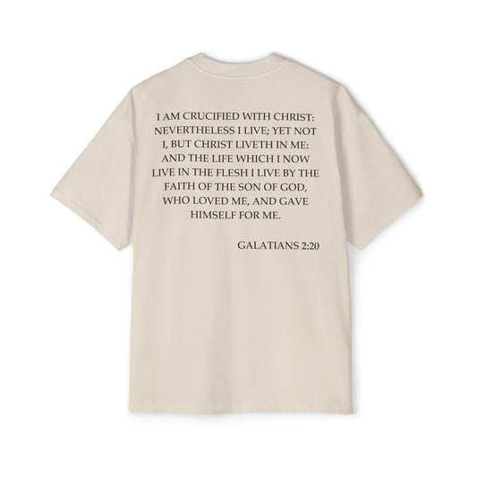 Back of Surrendered Apparel cream oversized Christian T-shirt featuring the Bible verse Galatians 2:20 in bold black text, providing a cozy fit perfect for cooler days and sharing faith